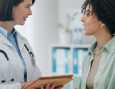 Female doctor with woman for diagnosis.