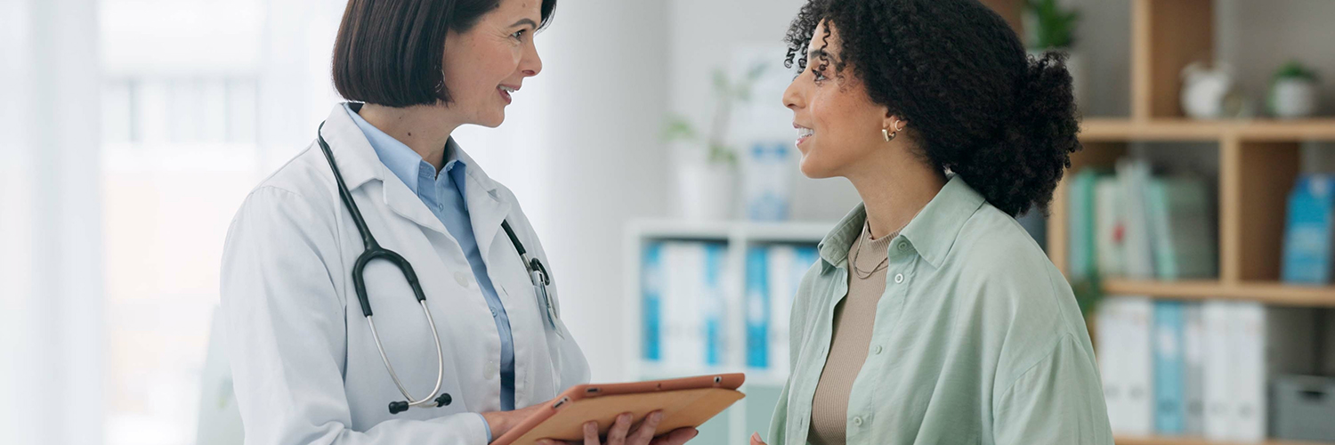 Female doctor with woman for diagnosis.