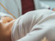 A female patient laying down while having an ultrasound on her abdomen.
