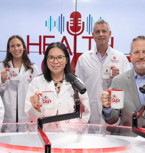 Experts from Stony Brook Medicine together in the podcast studio, holding branded coffee mugs.