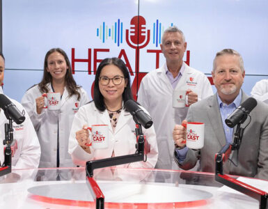 Experts from Stony Brook Medicine together in the podcast studio, holding branded coffee mugs.